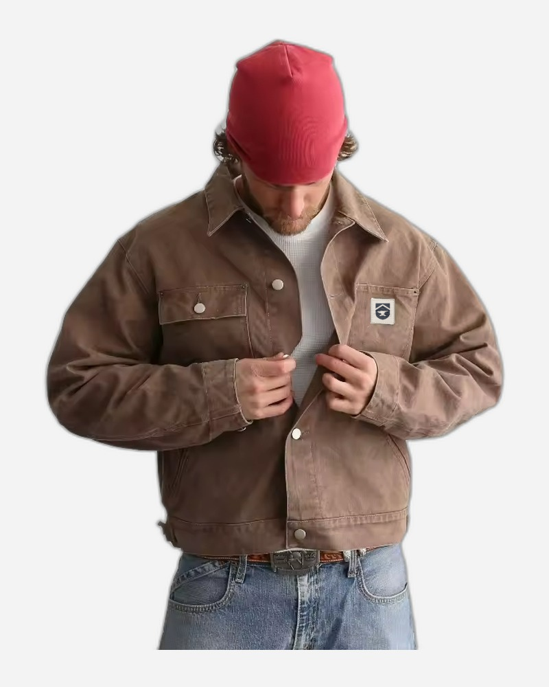 Model wearing boxy fit cropped canvas chore coat in vintage brown with work pants
