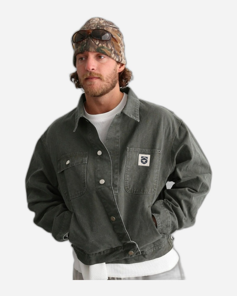 Model wearing boxy fit cropped canvas utility chore jacket in olive green