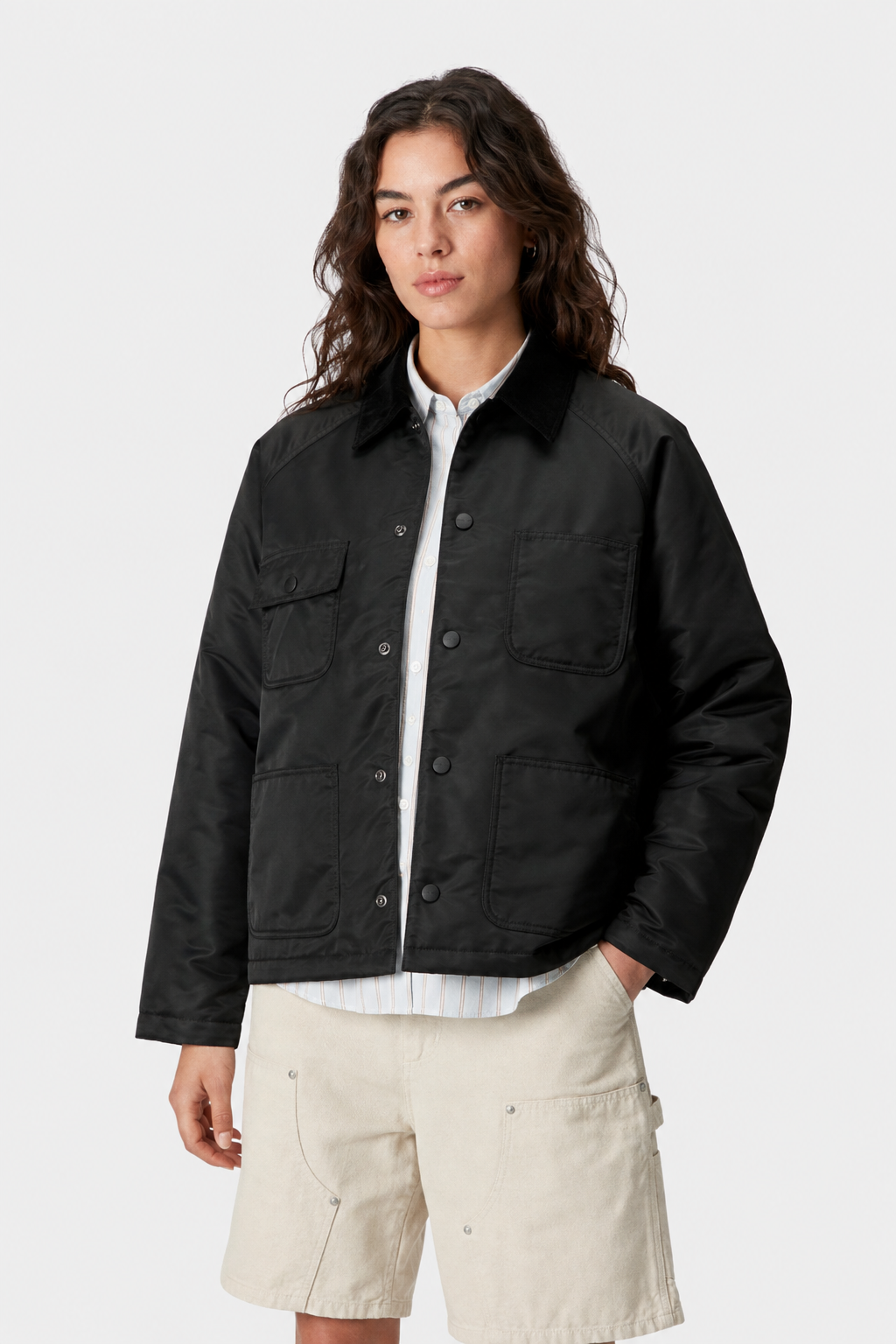 Model wearing a women's black chore coat with relaxed everyday workwear styling